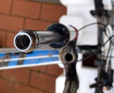 View of SID fork upside down with lowers removed showing rebound rod circlip