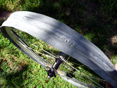 Tube fully split and folded backwards over rim