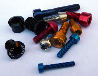Close-up of a selection of titanium and aluminum bolts used in bicycle bolt tuning